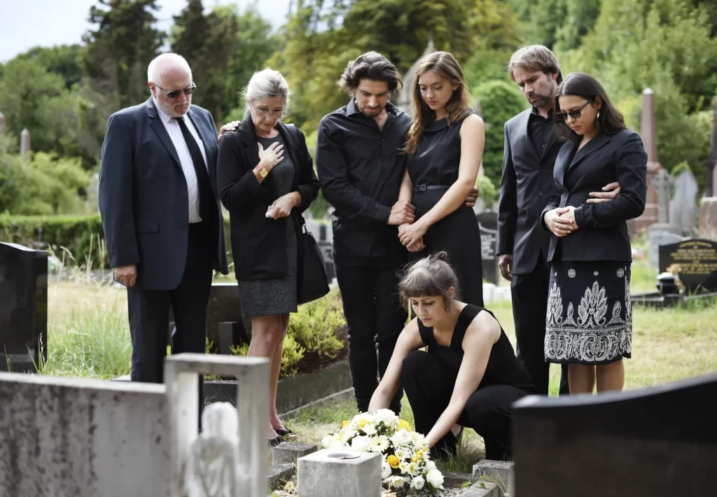 Family laying flowers on a grave